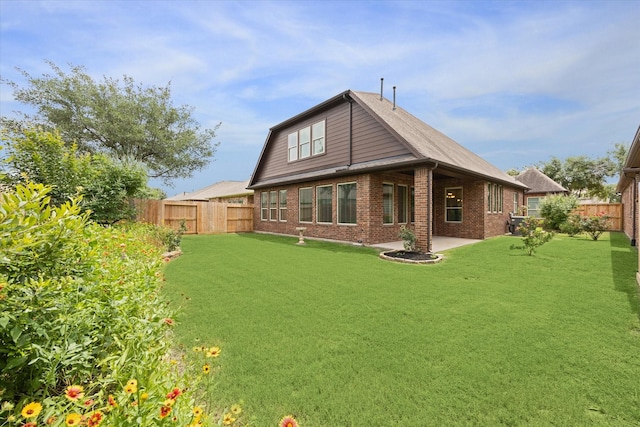 27018 Camirillo Creek Ln, Katy, TX 77494 - back of house with brick siding, a fenced backyard, a yard, and a patio
