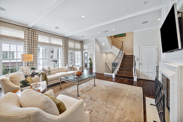 56 Audubon Hollow Ln, Houston, TX 77027 - living area featuring visible vents, stairs, wood finished floors, beam ceiling, and a fireplace with flush hearth