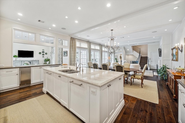 56 Audubon Hollow Ln, Houston, TX 77027 - kitchen with white cabinets, a sink, open floor plan, visible vents, and dark wood-style floors