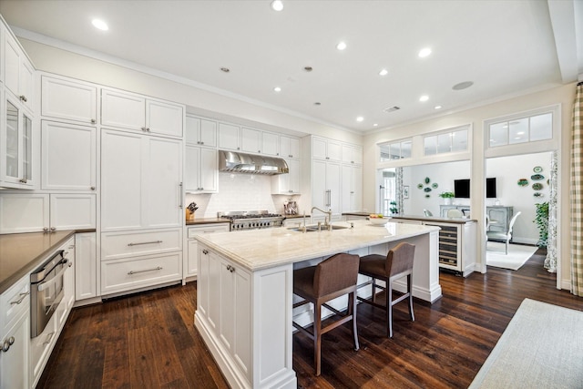 56 Audubon Hollow Ln, Houston, TX 77027 - kitchen with a sink, white cabinetry, and under cabinet range hood