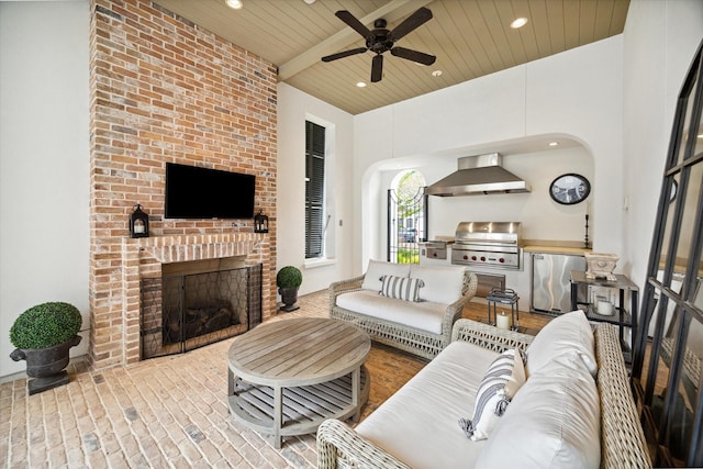 56 Audubon Hollow Ln, Houston, TX 77027 - living room with a brick fireplace, recessed lighting, wood ceiling, arched walkways, and a ceiling fan