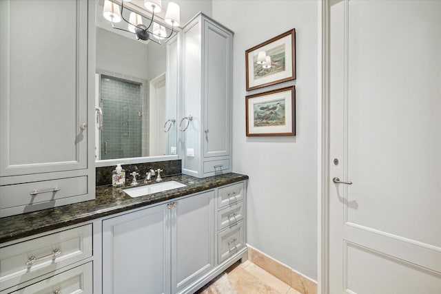 56 Audubon Hollow Ln, Houston, TX 77027 - bathroom featuring a tile shower, vanity, baseboards, tile patterned floors, and a notable chandelier