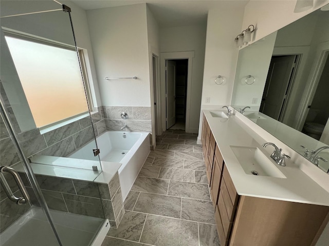 bathroom with a sink, a bath, and a stall shower
