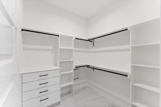 walk in closet with marble finish floor