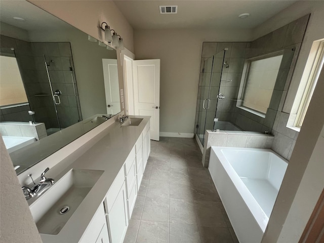 bathroom featuring visible vents, a sink, a bath, and a stall shower