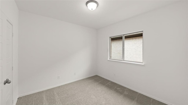 spare room with carpet flooring and baseboards