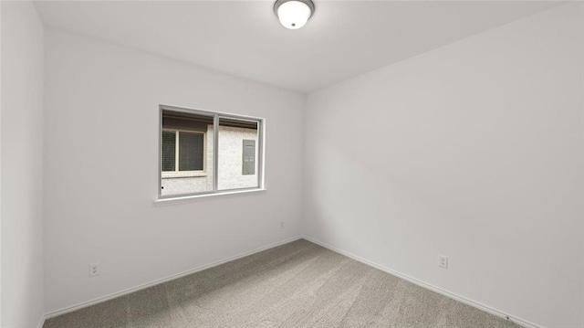 unfurnished room featuring baseboards and carpet