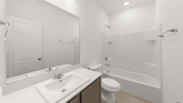 bathroom featuring toilet, bathing tub / shower combination, and vanity
