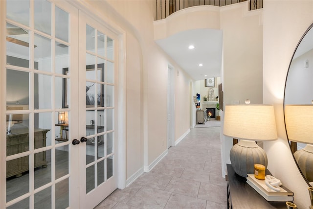hallway with french doors, recessed lighting, and baseboards
