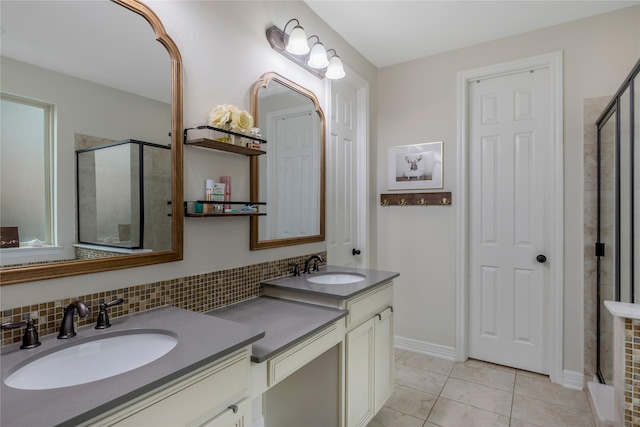 bathroom featuring double vanity, a sink, and a shower stall
