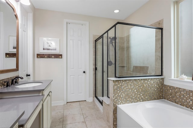 bathroom featuring vanity, a shower stall, tile patterned floors, and a garden tub