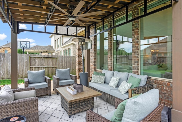sunroom / solarium featuring ceiling fan and outdoor lounge area