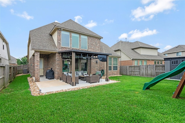 back of house featuring brick siding, an outdoor hangout area, a playground, and a patio area