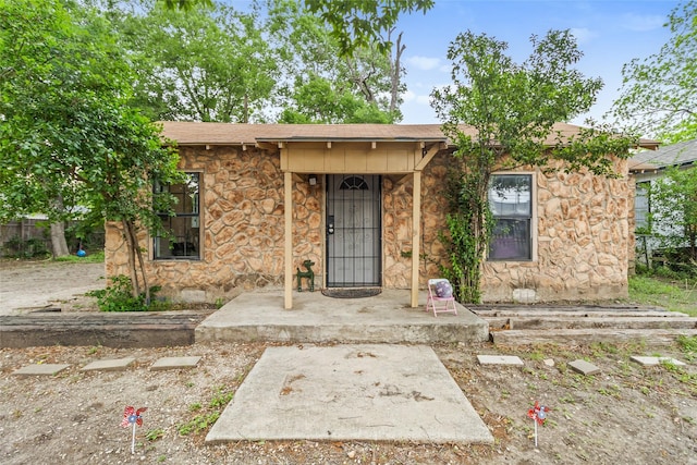 925 New Laredo Hwy, San Antonio, TX 78211 - view of front facade featuring a shingled roof and stone siding
