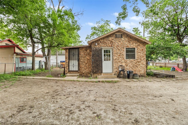 925 New Laredo Hwy, San Antonio, TX 78211 - rear view of property featuring entry steps, fence, and stone siding