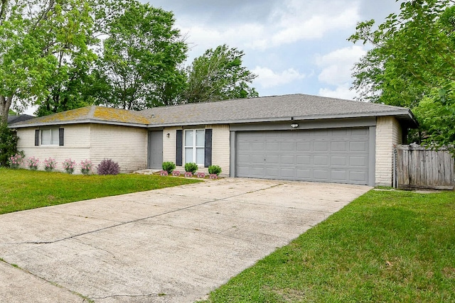 single story home with fence, brick siding, a garage, a front yard, and concrete driveway
