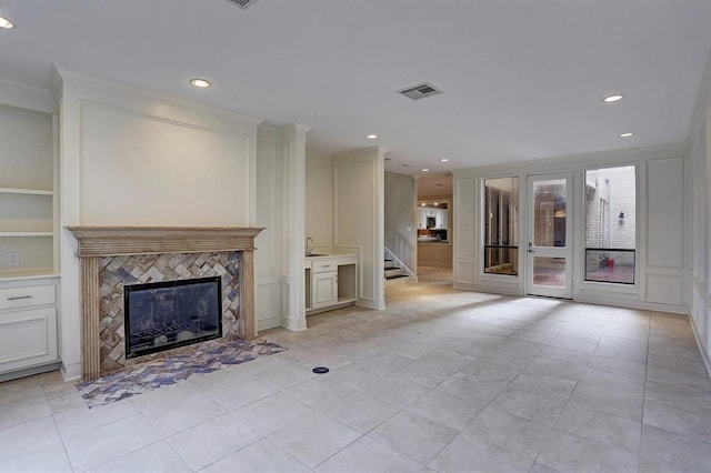unfurnished living room with visible vents, recessed lighting, and a premium fireplace