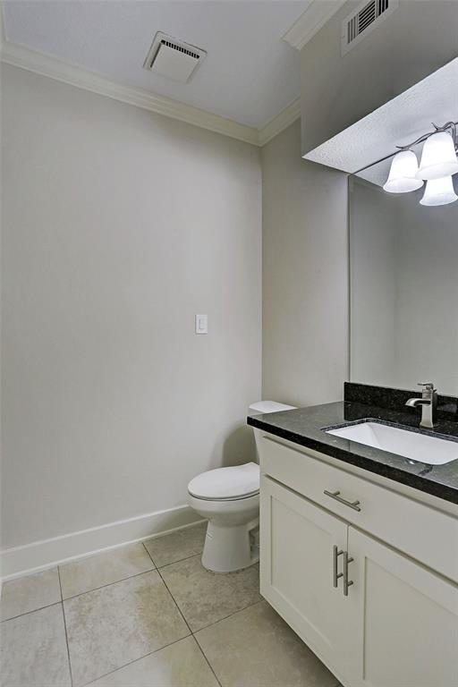 bathroom featuring visible vents, ornamental molding, tile patterned floors, and vanity