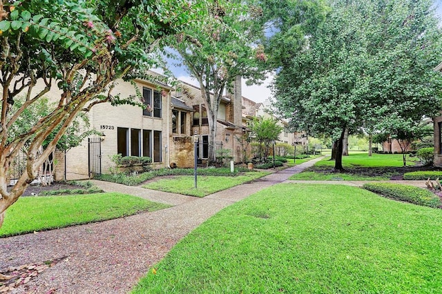 view of property's community with a lawn
