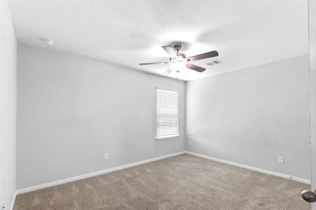 empty room featuring baseboards, ceiling fan, carpet, and visible vents