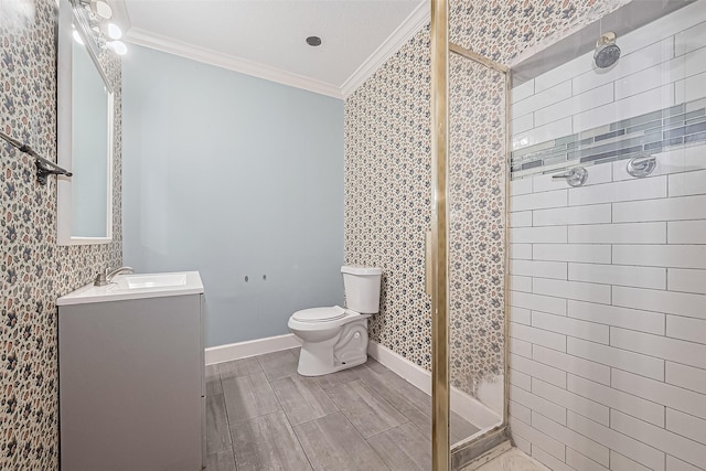 bathroom with vanity, ornamental molding, toilet, and a shower stall