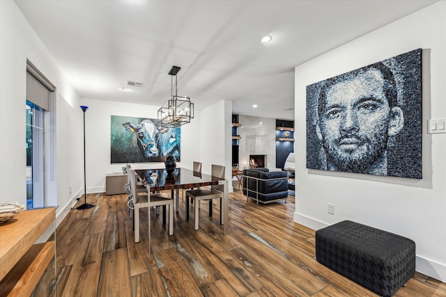 dining area featuring visible vents, wood finished floors, baseboards, a notable chandelier, and recessed lighting