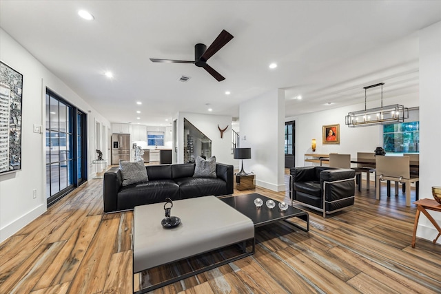 living area featuring light wood-style floors, recessed lighting, and visible vents