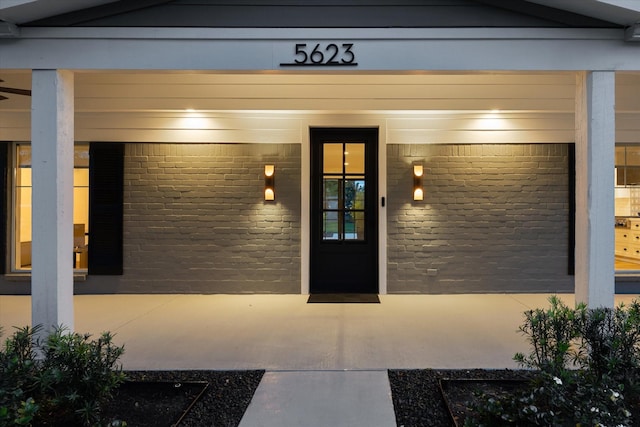 doorway to property featuring brick siding