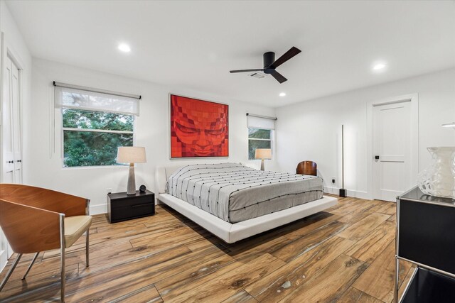 bedroom featuring multiple windows, wood-type flooring, recessed lighting, and ceiling fan