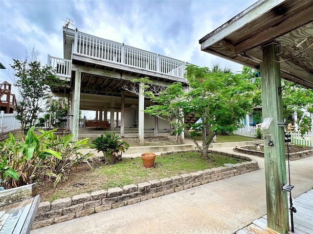 12828 E Madrid, Galveston, TX 77554 - exterior space with fence and a deck