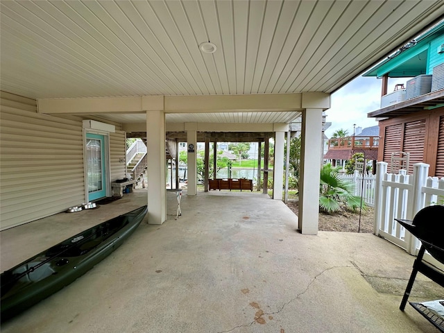 12828 E Madrid, Galveston, TX 77554 - view of patio featuring stairs, fence, and cooling unit