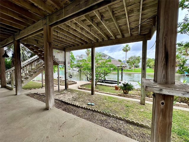 12828 E Madrid, Galveston, TX 77554 - view of patio with a water view, boat lift, and stairway