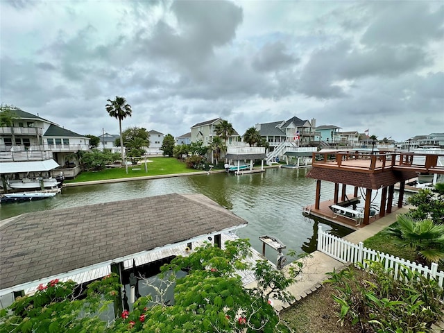 12828 E Madrid, Galveston, TX 77554 - dock area featuring a water view, fence, a residential view, and boat lift