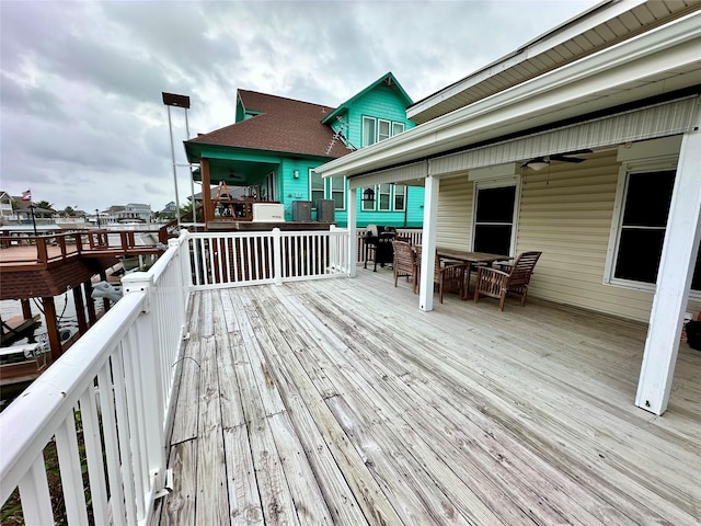 12828 E Madrid, Galveston, TX 77554 - wooden terrace with outdoor dining area and area for grilling