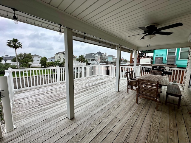 12828 E Madrid, Galveston, TX 77554 - deck with outdoor dining area, a ceiling fan, and a residential view