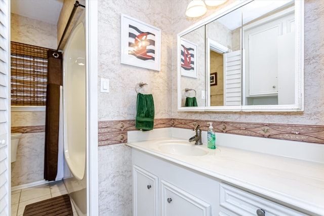 12828 E Madrid, Galveston, TX 77554 - bathroom with vanity, toilet, and tile patterned floors