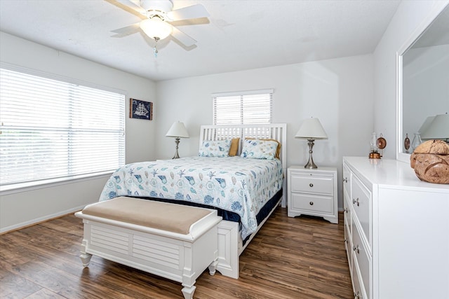 12828 E Madrid, Galveston, TX 77554 - bedroom with baseboards, a ceiling fan, and dark wood-style flooring