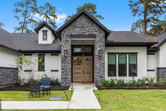 view of front of property with stucco siding, a front yard, and stone siding
