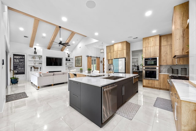 kitchen featuring a ceiling fan, a large island, modern cabinets, a sink, and stainless steel appliances
