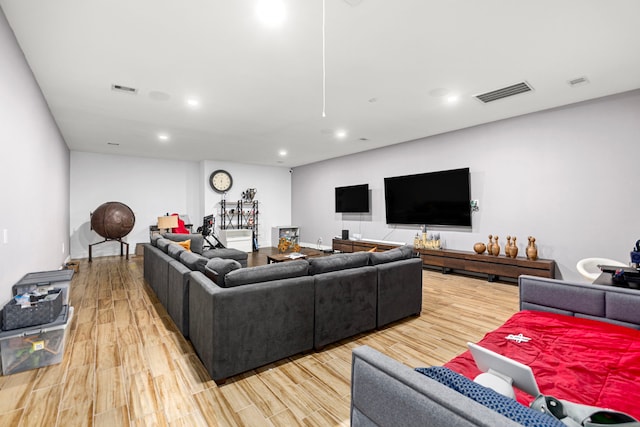 living area featuring visible vents, recessed lighting, and light wood-style flooring