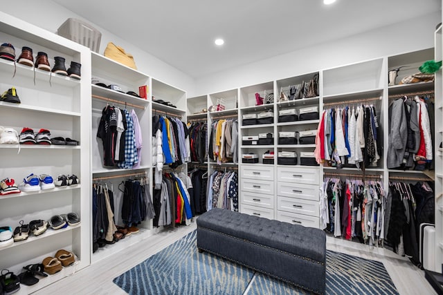 walk in closet with wood finished floors