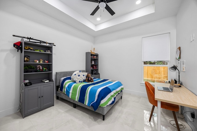 bedroom with baseboards, ceiling fan, a tray ceiling, and recessed lighting