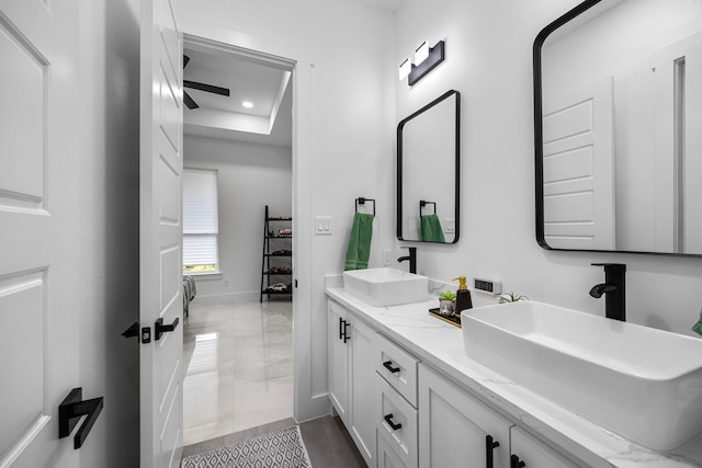 full bathroom featuring double vanity, baseboards, recessed lighting, and a sink