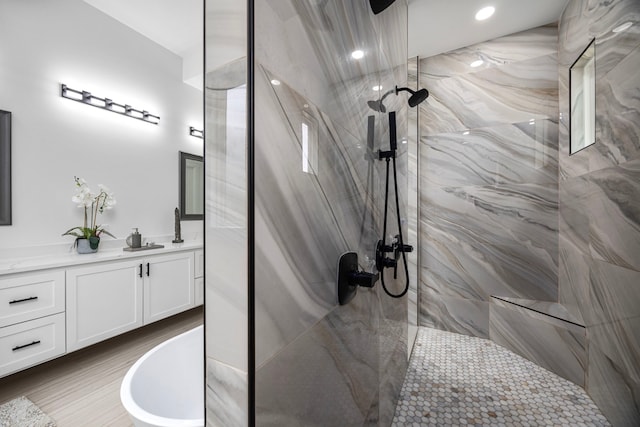 bathroom featuring vanity, recessed lighting, and a marble finish shower