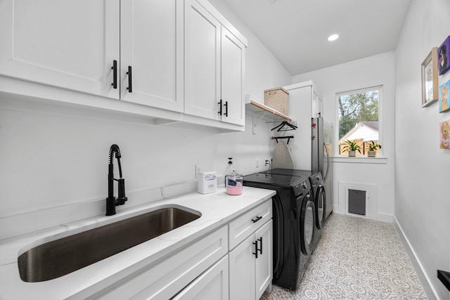 laundry room featuring independent washer and dryer, cabinet space, a sink, baseboards, and recessed lighting