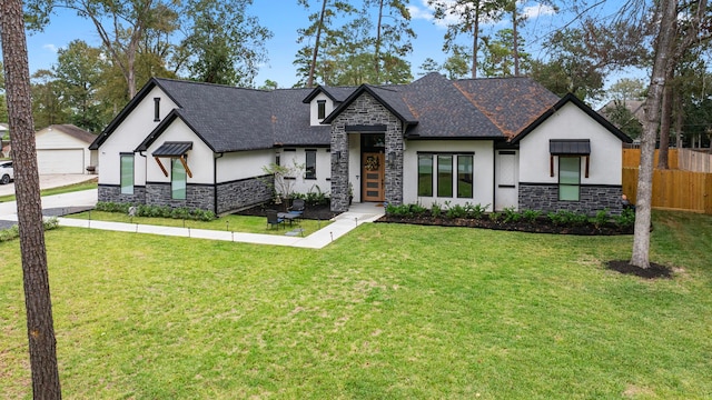view of front of property with fence, stucco siding, a front yard, and stone siding