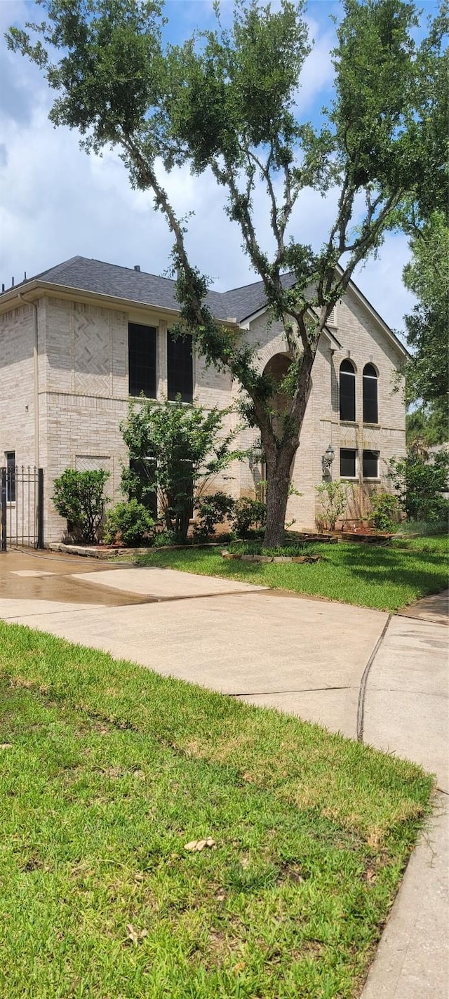 view of front of house with a front lawn and stone siding