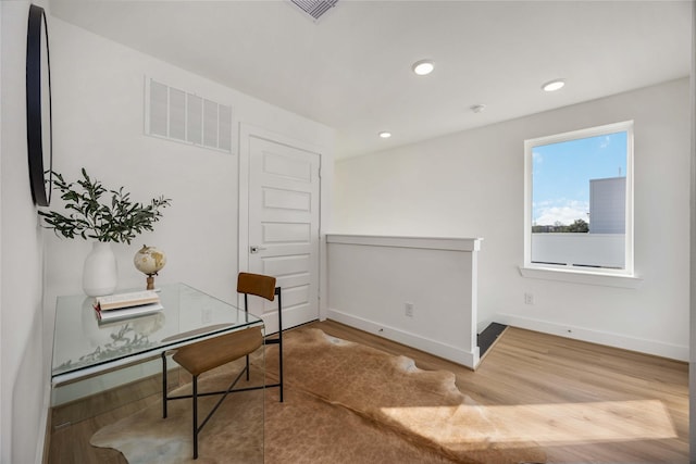office space with baseboards, recessed lighting, visible vents, and wood finished floors