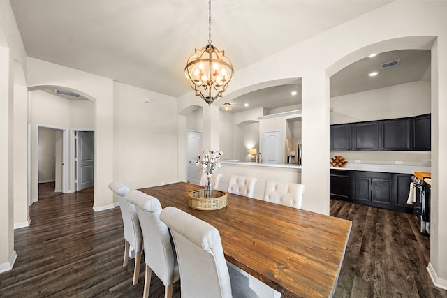 1074 Pleasant Bnd, Conroe, TX 77301 - dining room featuring dark wood-style flooring, arched walkways, a chandelier, baseboards, and recessed lighting