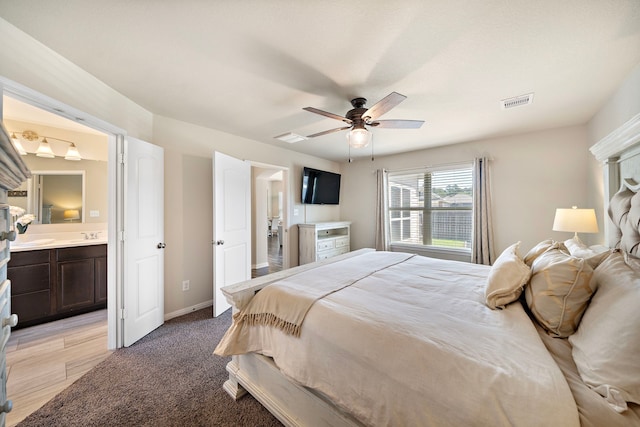 1074 Pleasant Bnd, Conroe, TX 77301 - bedroom featuring baseboards, a ceiling fan, and connected bathroom